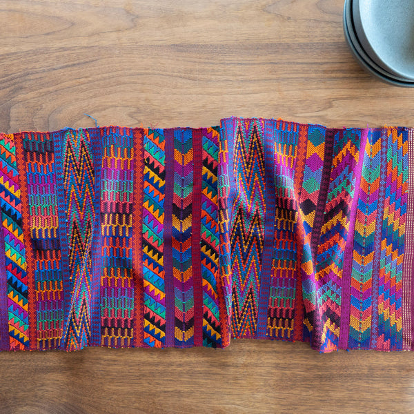 Colorful woven textile on a wooden surface